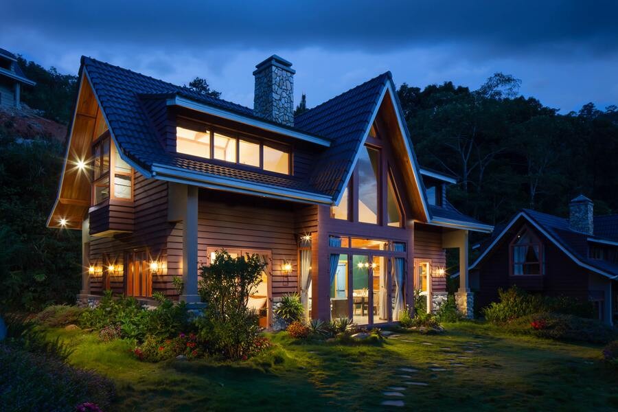 A home’s exterior shines in the darkness with a landscape lighting installation.